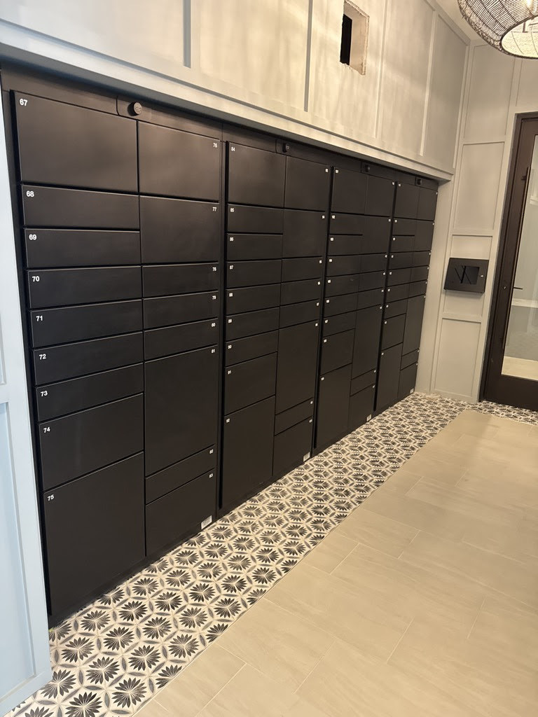 Luxer One® indoor package locker bank with numbered compartments in a Class-A residential lobby