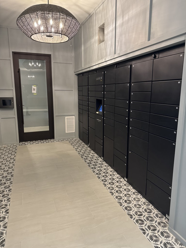 Luxer One® branded indoor package locker installation in a residential lobby