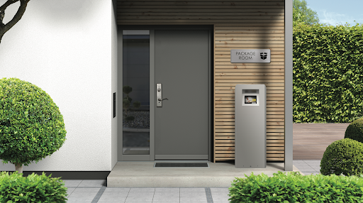 Tall weatherproof Luxer One outdoor package locker kiosk under a wood pergola in a multifamily courtyard
